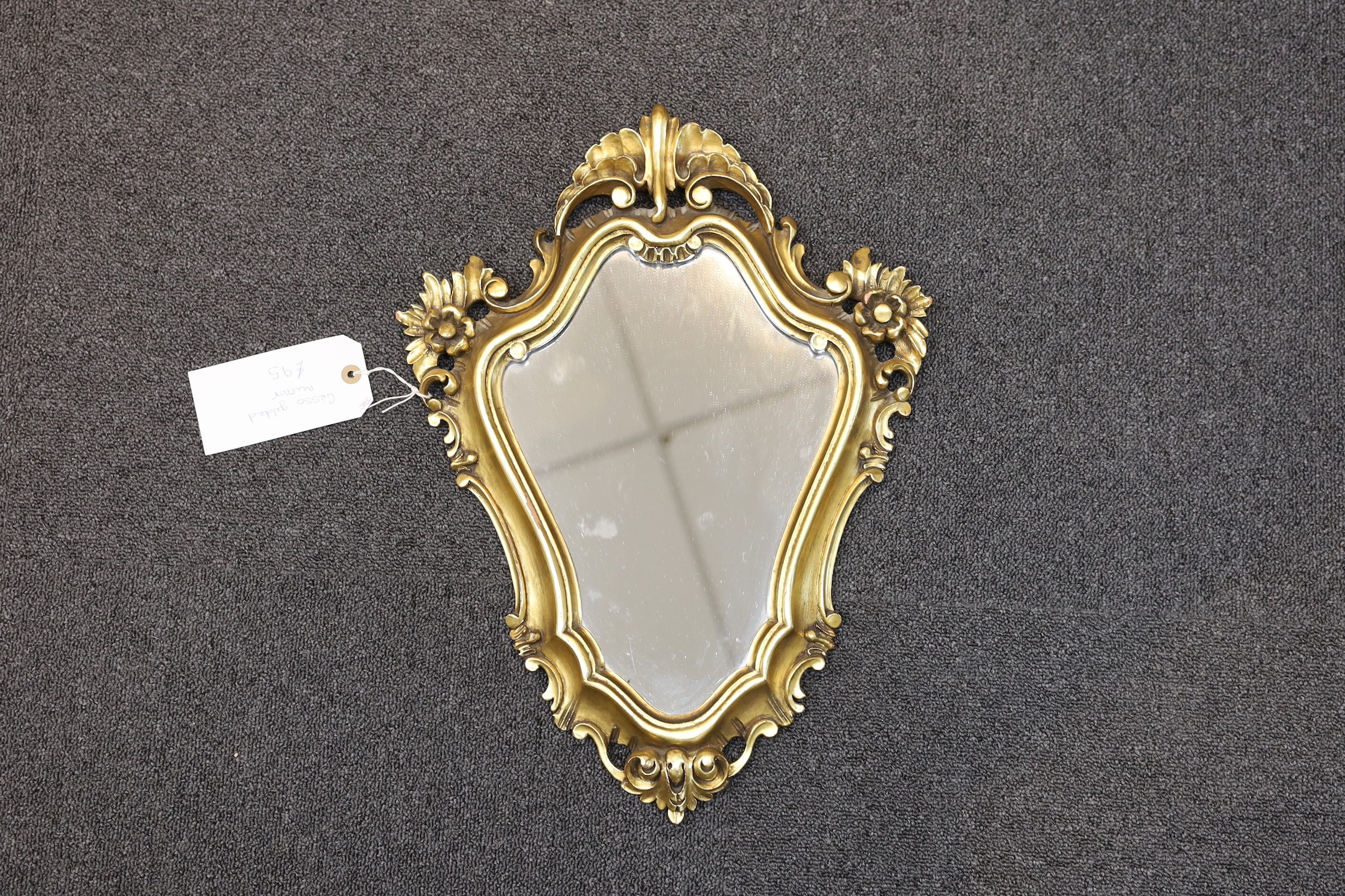 A pair of George III style giltwood cartouche wall mirrors, height 60cm, together with two similar smaller cartouche wall mirrors